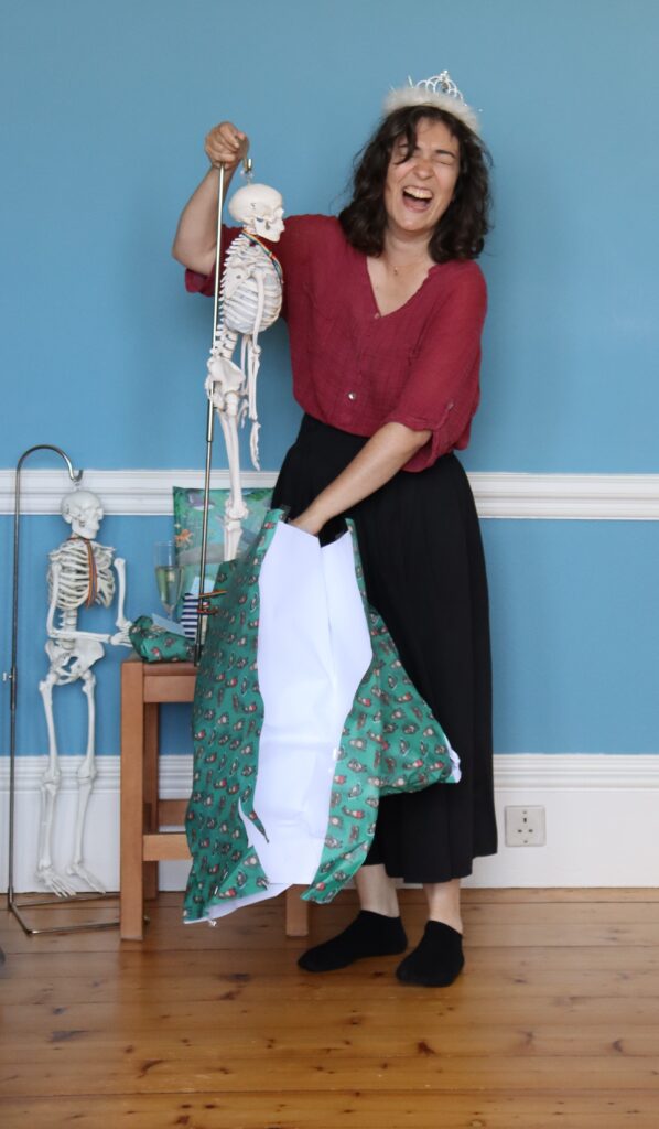 Eleni unwrapping her graduation present, a model skeleton