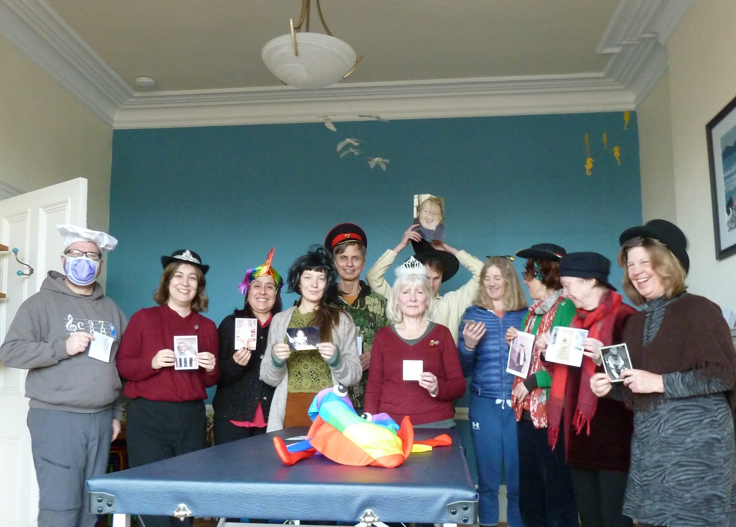 The EATS team at our end of term Christmas party, all wearing silly hats and holding up baby photos of themselves