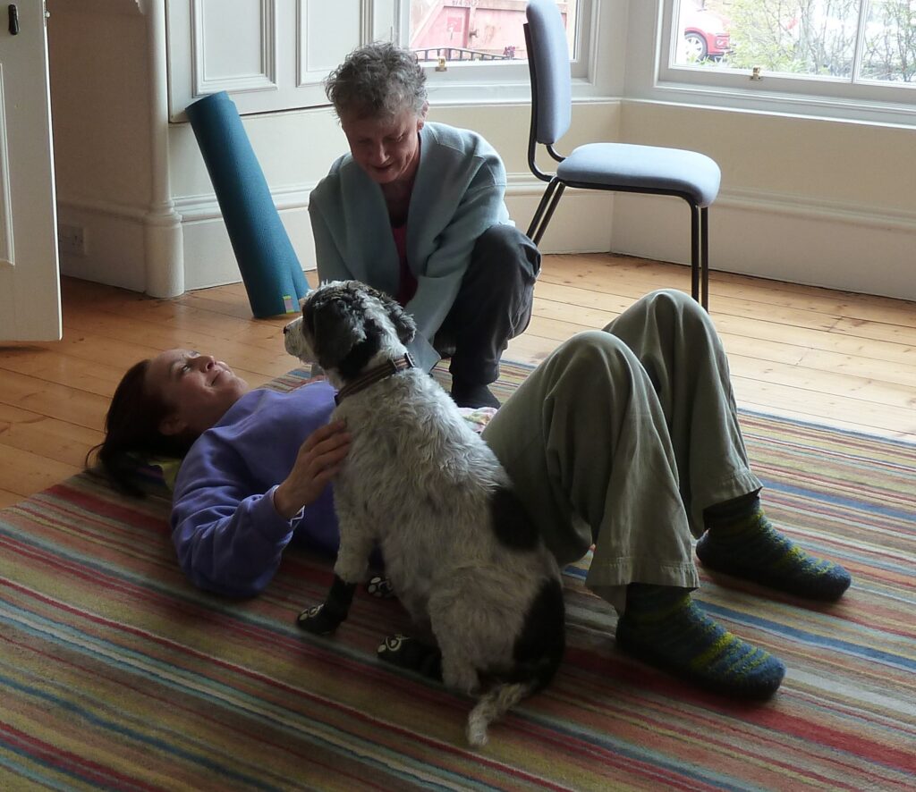 Head of Edinburgh Alexander Training School, Julia Woodman working with trainee who is lying on the floor