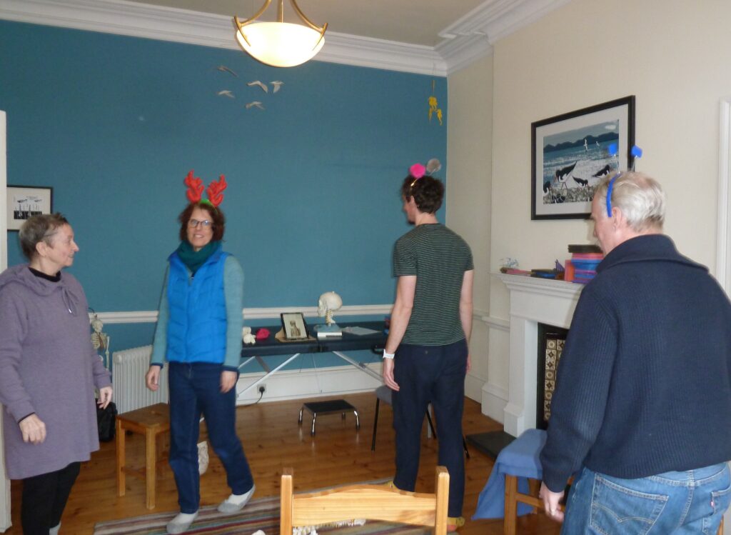 Photo of Alexander teacher, Sandra at Edinburgh Alexander Training School working with trainees on poise and balance