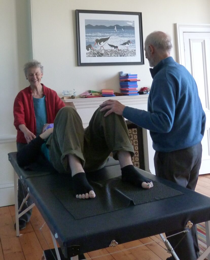 Photo of Alexander teachers at Edinburgh Alexander Training School working with someone lying on a table