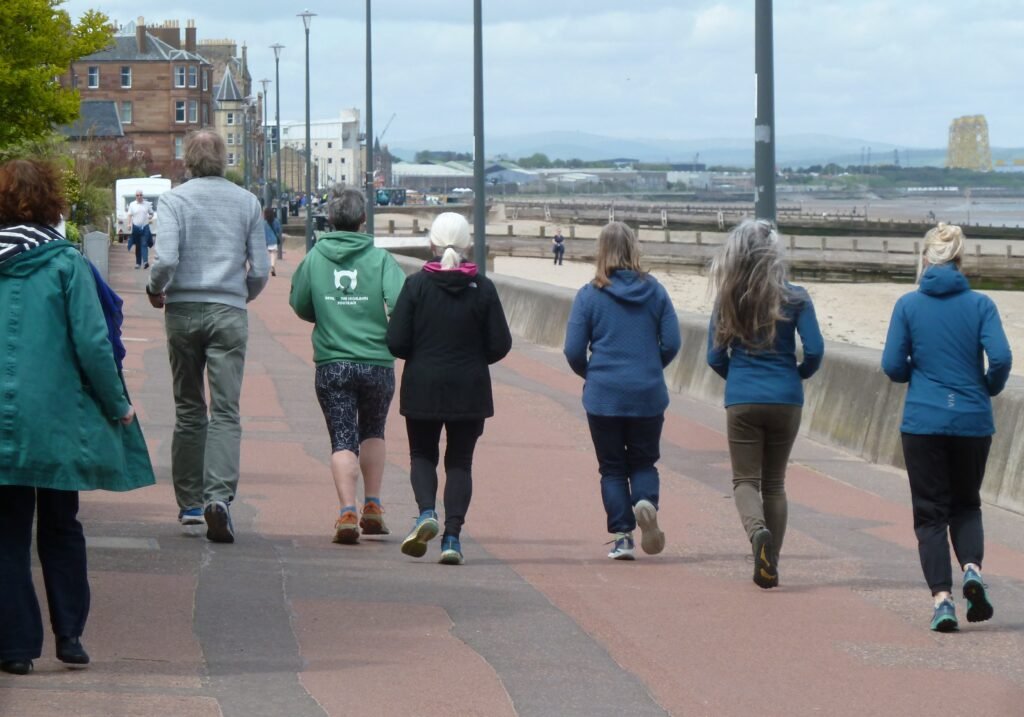 Photo of group running along Portobello promenade during Malcolm Balk running session at Edinburgh Alexander Training School